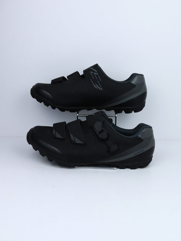Shimano SH-ME3 (or SH-ME301) mountain bike shoes with a rubber outsole and two hook-and-loop straps.