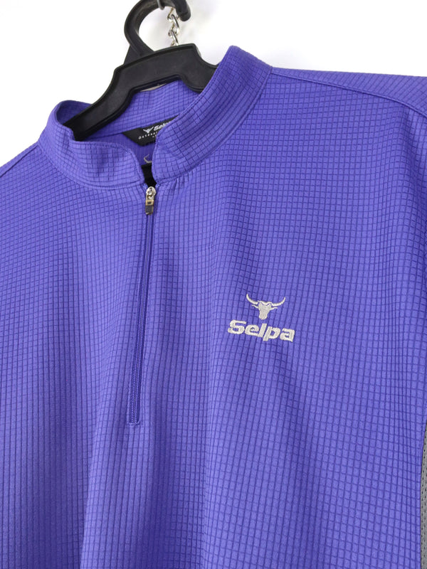 Selpa cycling jersey in purple with a quarter-zip neck and gray side panels.