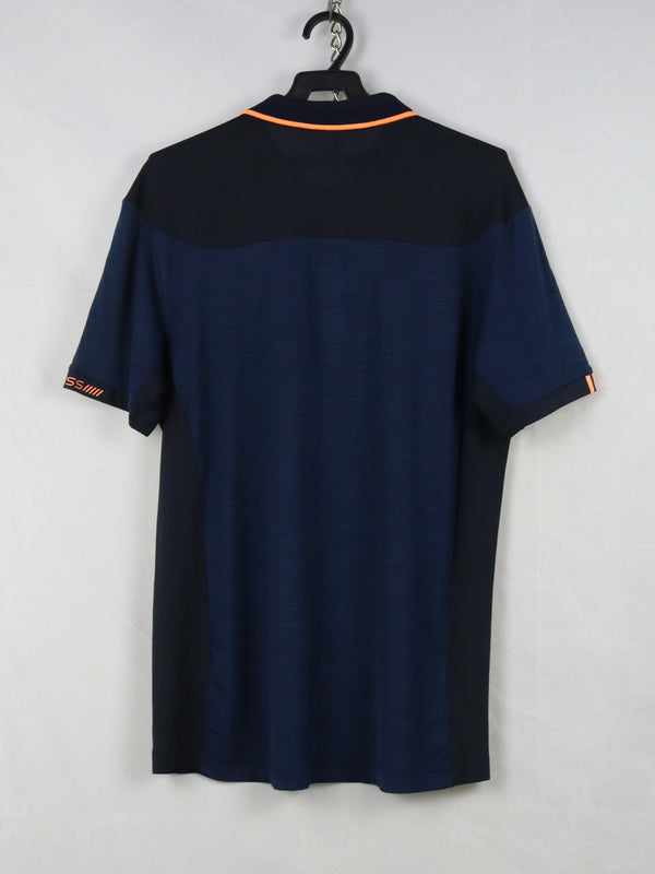 K-Swiss navy blue and black polo shirt with orange trim.
