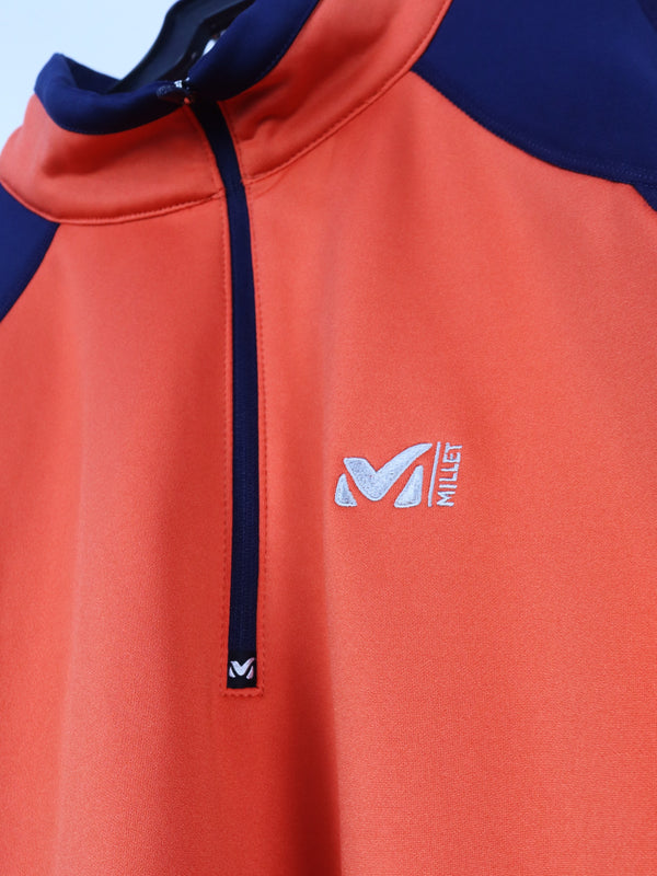 Millet Morpho Zip long-sleeved hiking tee-shirt in orange and blue made with Polartec Power Dry fabric.