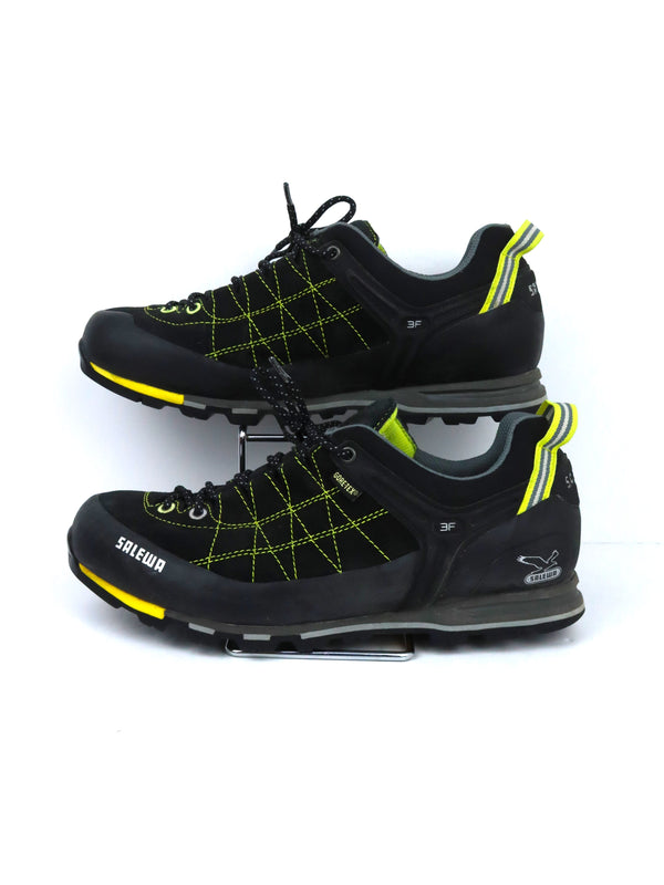 Salewa Mountain Trainer 2 GTX low-cut hiking shoe in a black and yellow color scheme.
