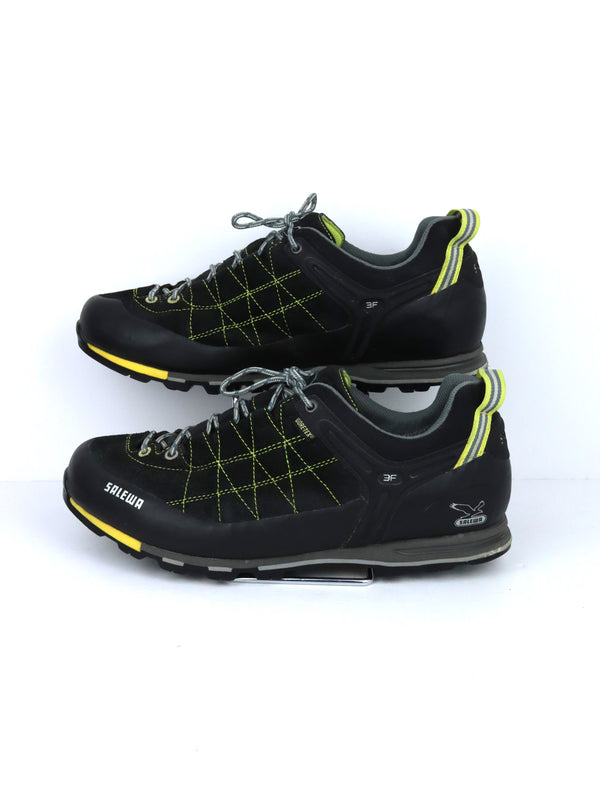 Salewa Mountain Trainer GTX hiking shoes in black with yellow accents, featuring a GORE-TEX lining and a Vibram sole.