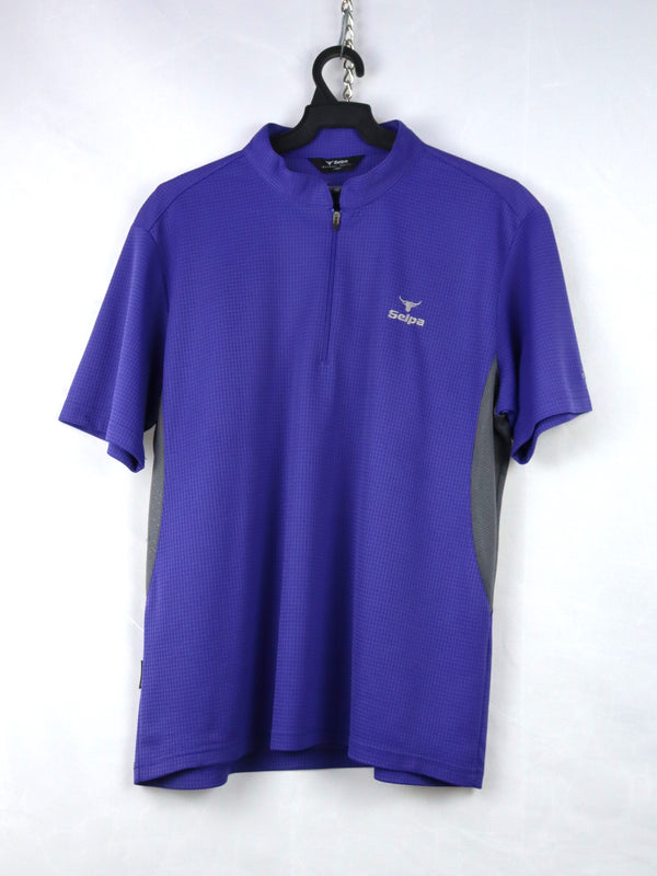 Selpa cycling jersey in purple with a quarter-zip neck and gray side panels.