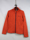 VAUDE Women's Rienza IV fleece jacket in an orange melange color.