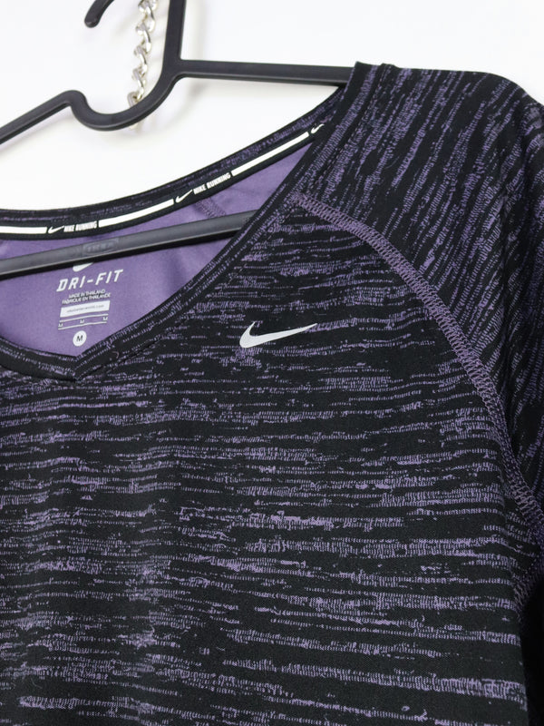 Nike Dri-FIT running top made of a polyester microfiber blend designed to wick away sweat