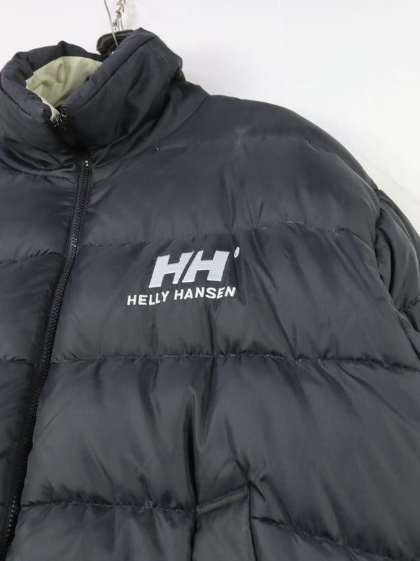 Helly Hansen HH Urban Reversible Puffer Jacket in black, featuring synthetic blowable insulation and ripstop fabric.