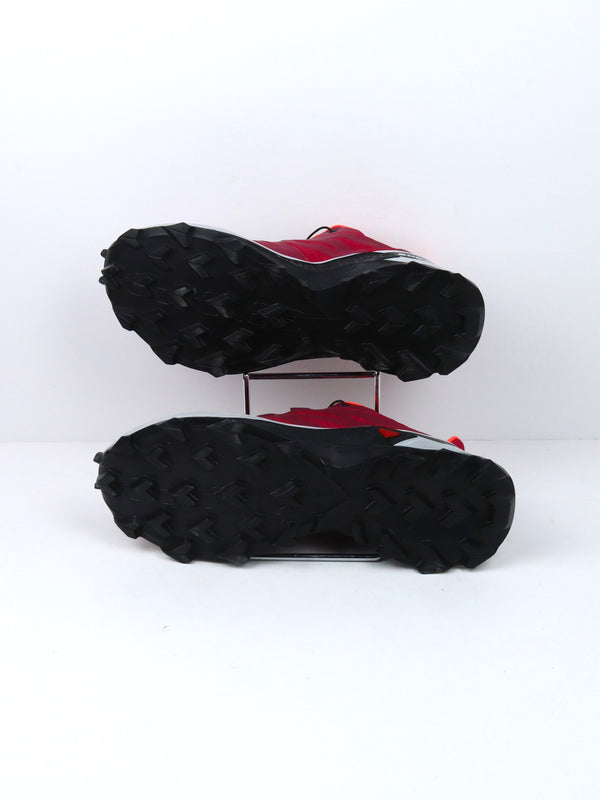 Salomon Supercross trail running shoes in red with black and white accents.