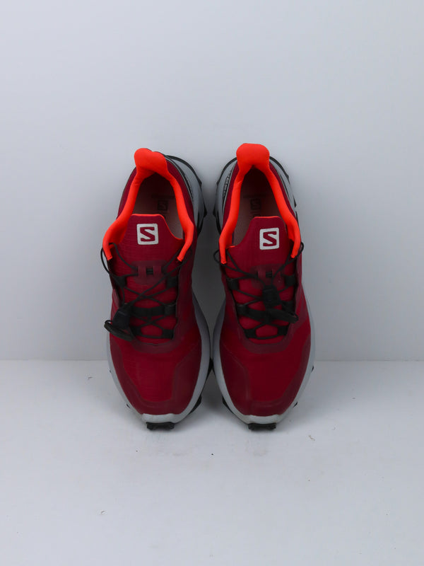 Salomon Supercross trail running shoes in red with black and white accents.